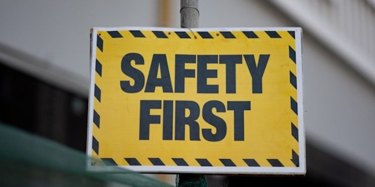 A yellow and black sign that says Safety First.