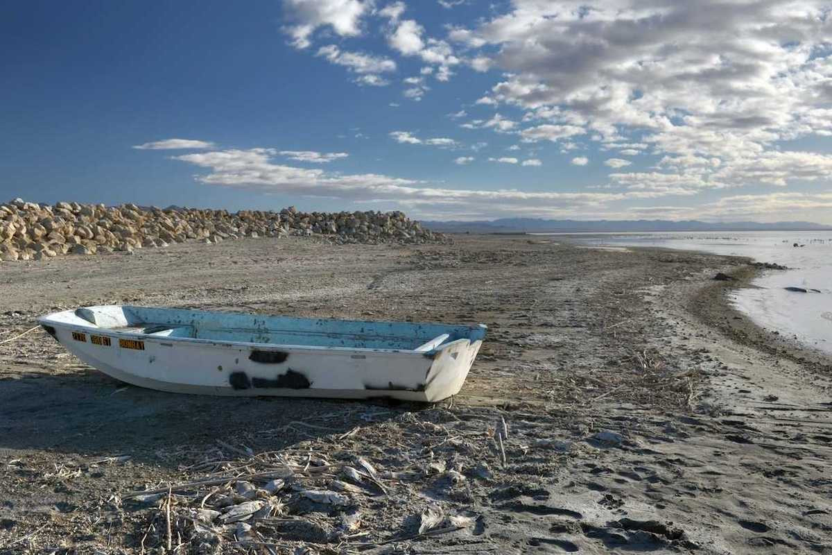 Abandoned derelict rowboat beached on the shore of the Salton Sea