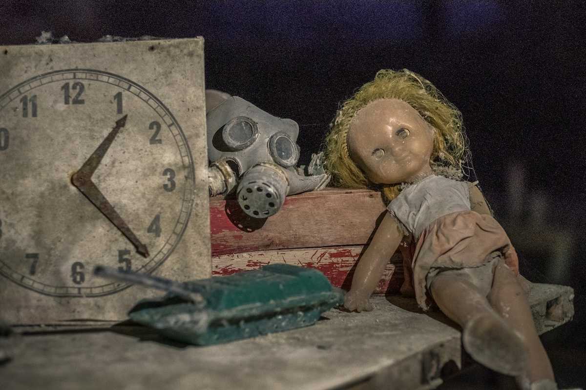 Abandoned items from kindergarten — gas mask, doll, toy tank in Chernobyl, Kyiv Oblast, Ukraine following Chernobyl nuclear disaster in 1986