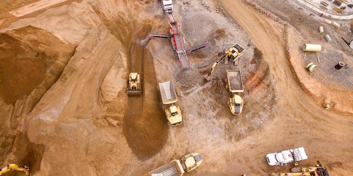 aerial photography of dump trucks in a mining pit.