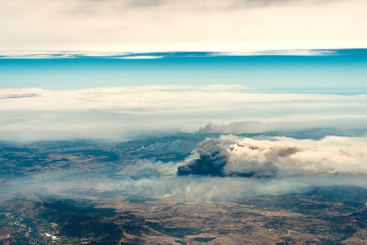 Aerial view of a big column of smoke from forest fire in southern Chile