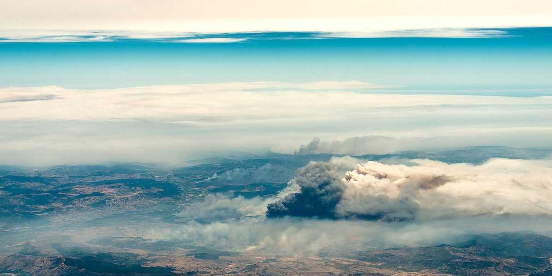 Aerial view of a big column of smoke from forest fire in southern Chile