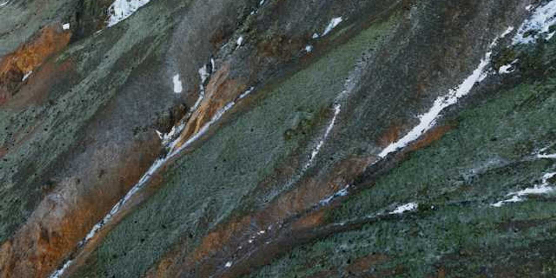 Aerial view of a mountain with snow on it