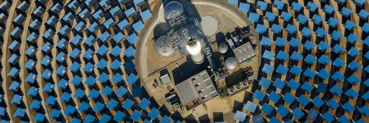 aerial view of a solar power generating facility with panels deployed in a circular configuration.