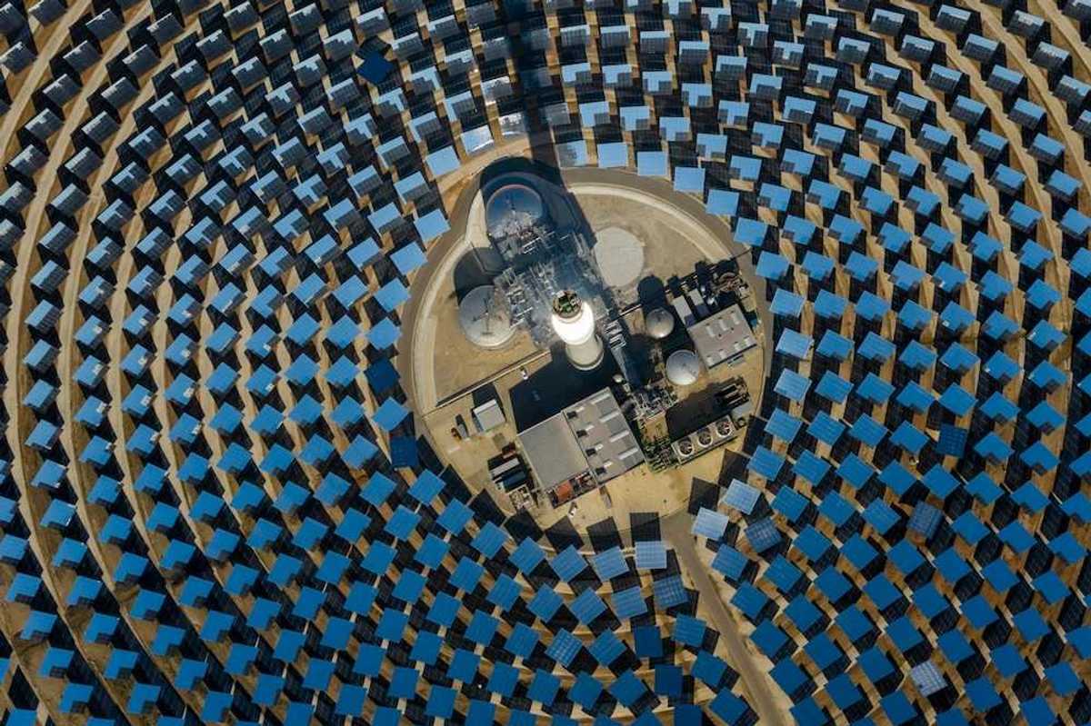 aerial view of a solar power generating facility with panels deployed in a circular configuration.