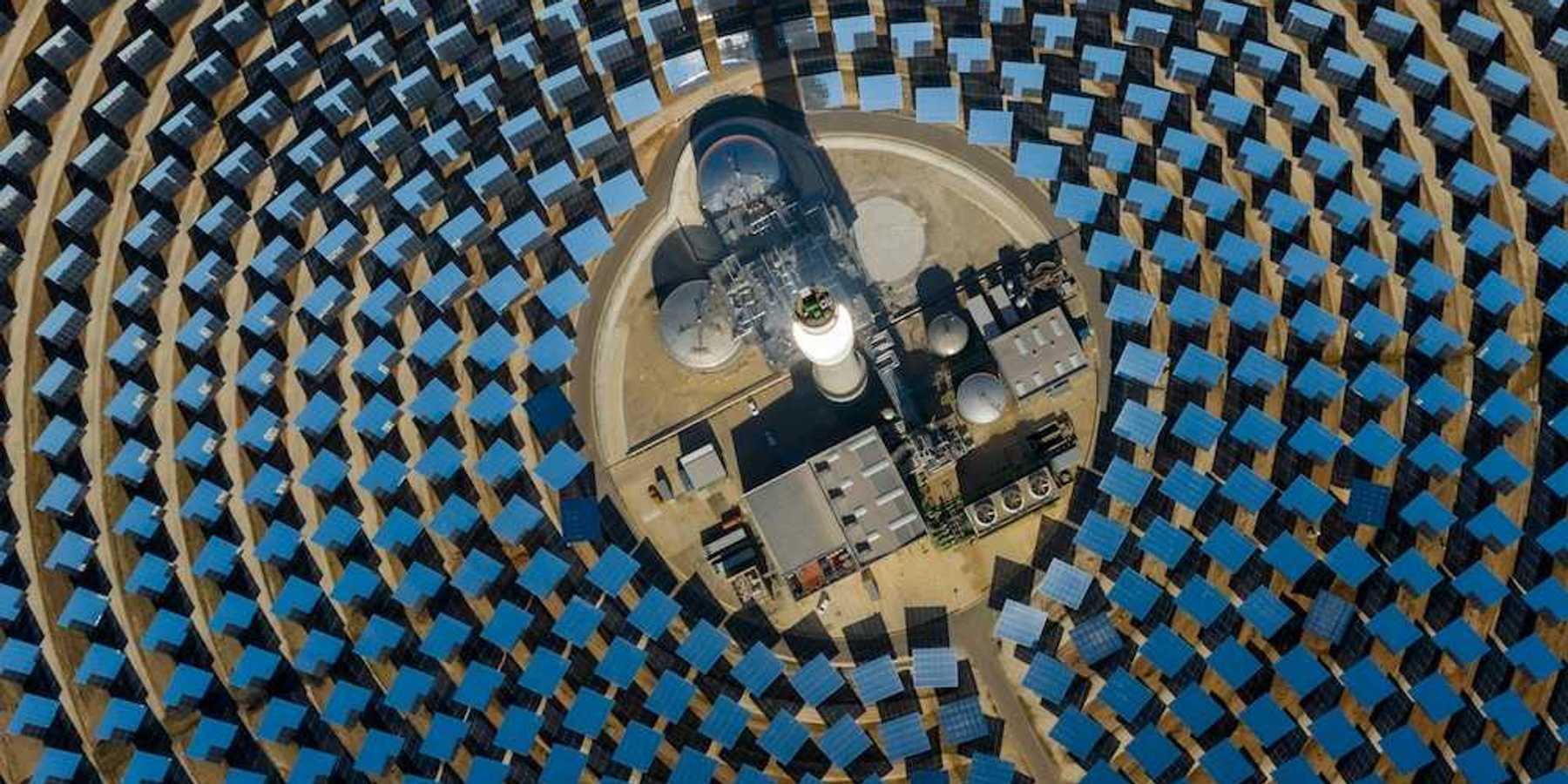 aerial view of a solar power generating facility with panels deployed in a circular configuration.