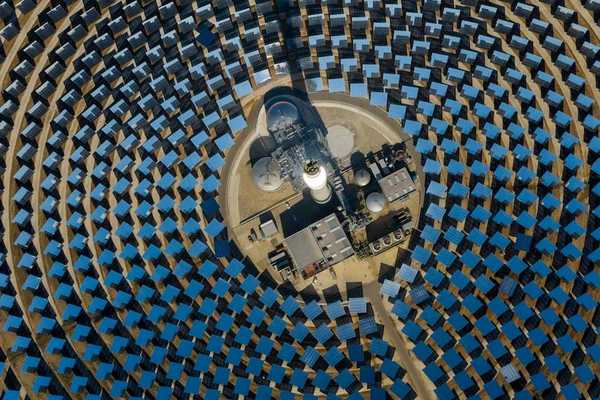 aerial view of a solar power generating facility with panels deployed in a circular configuration.