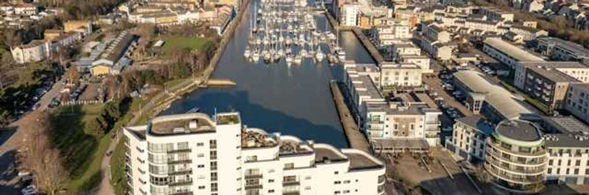 Aerial view of city buildings and boats on water