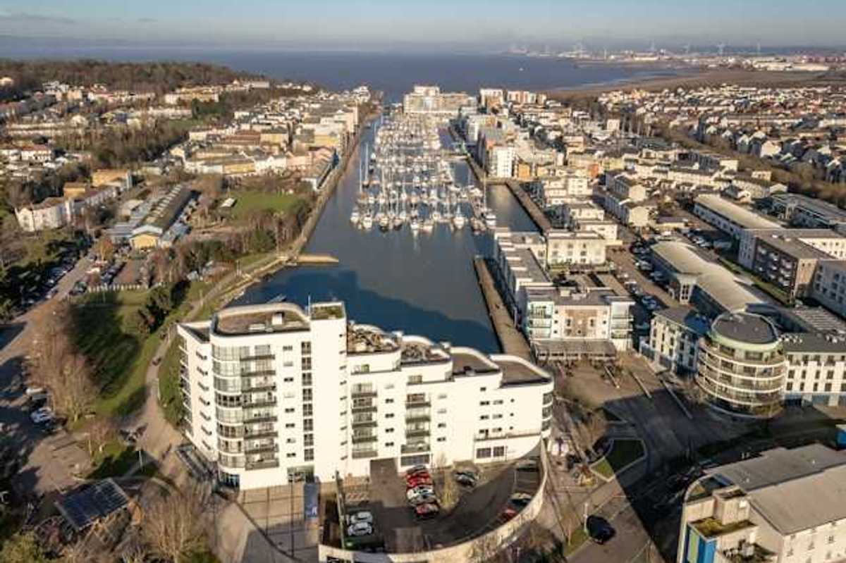 Aerial view of city buildings and boats on water