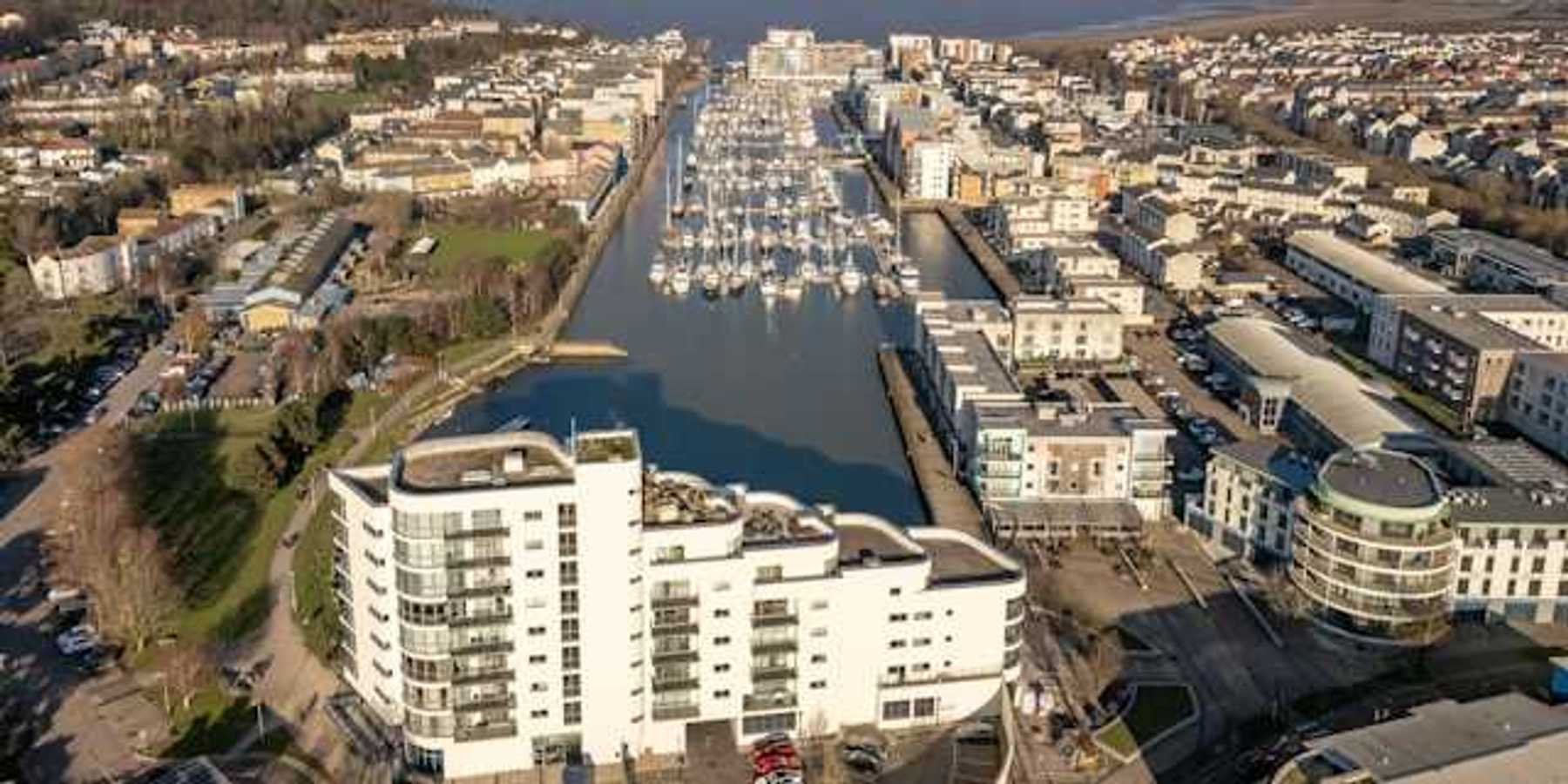 Aerial view of city buildings and boats on water