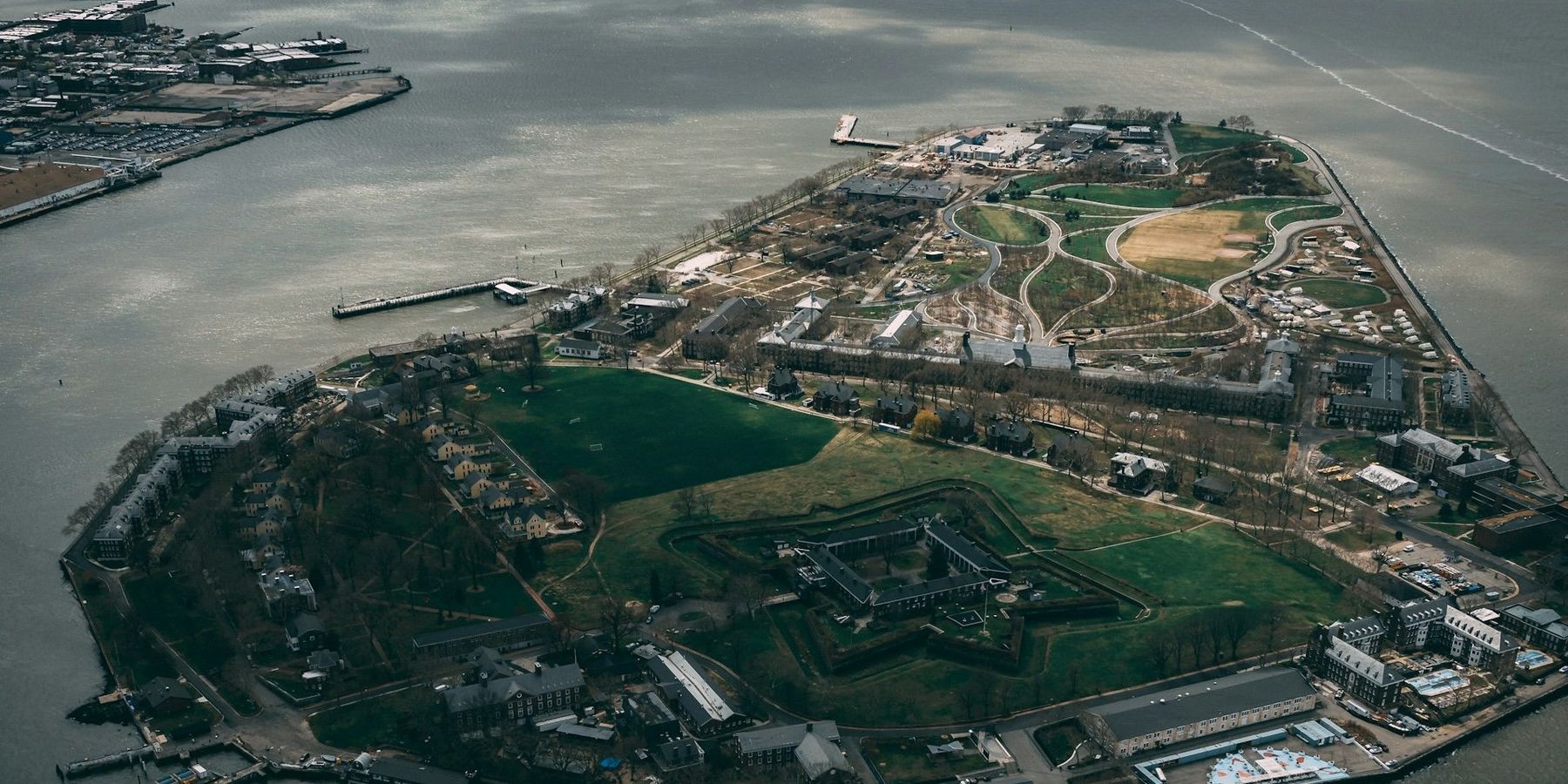 aerial view of Governors Island, New York Harbor on a partly cloudy day.