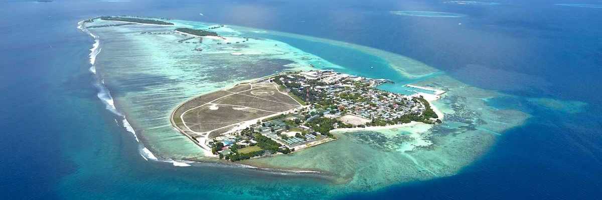 Aerial view of Himmafushi island in the Maldives exemplifying sea level vulnerability