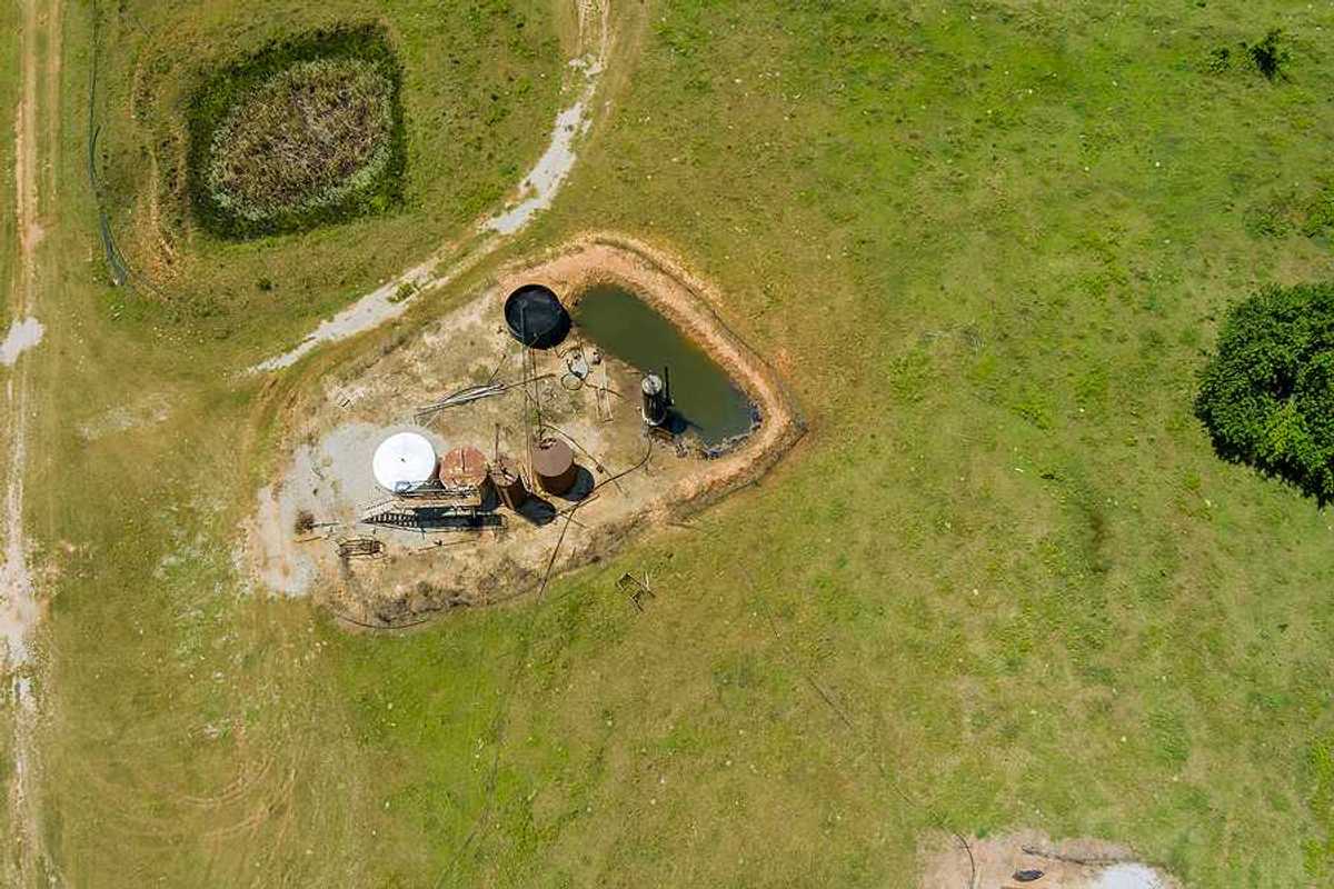 Aerial view of oil well pump jack in Oklahoma on a sunny day