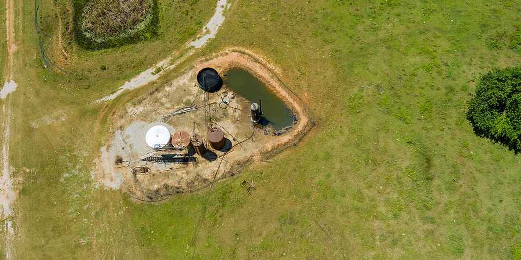 Aerial view of oil well pump jack in Oklahoma on a sunny day