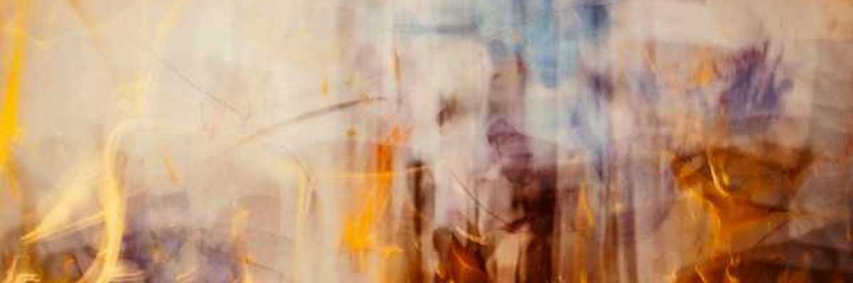 An abstract view of flames with smoke rising from them