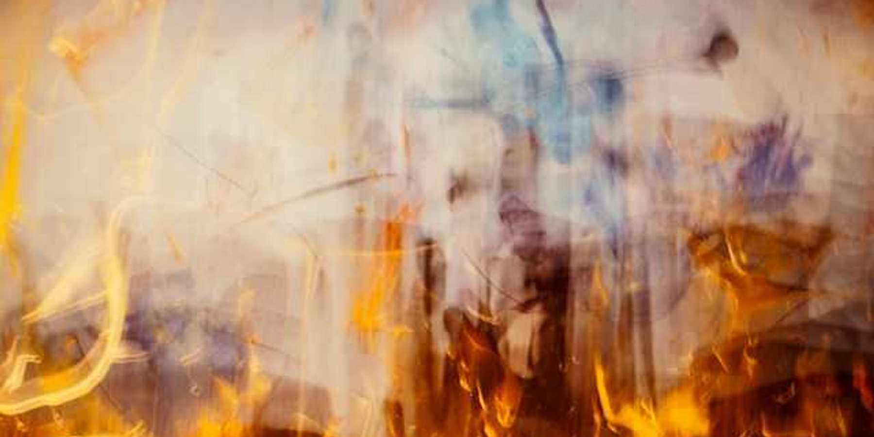 An abstract view of flames with smoke rising from them