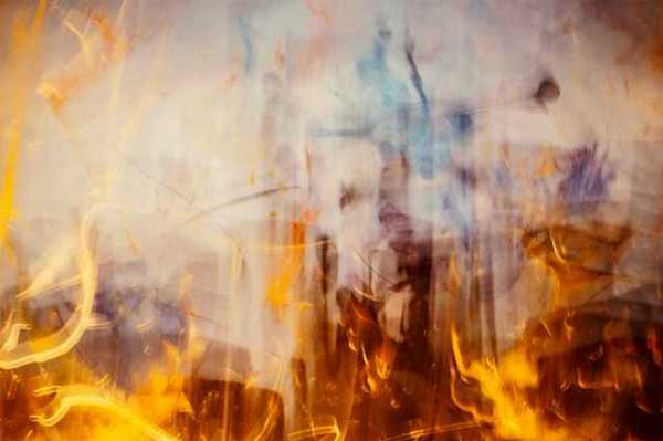 An abstract view of flames with smoke rising from them