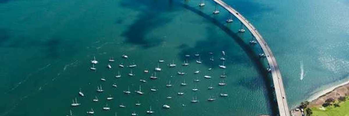 An aerial view of a body of water with a bridge crossing it