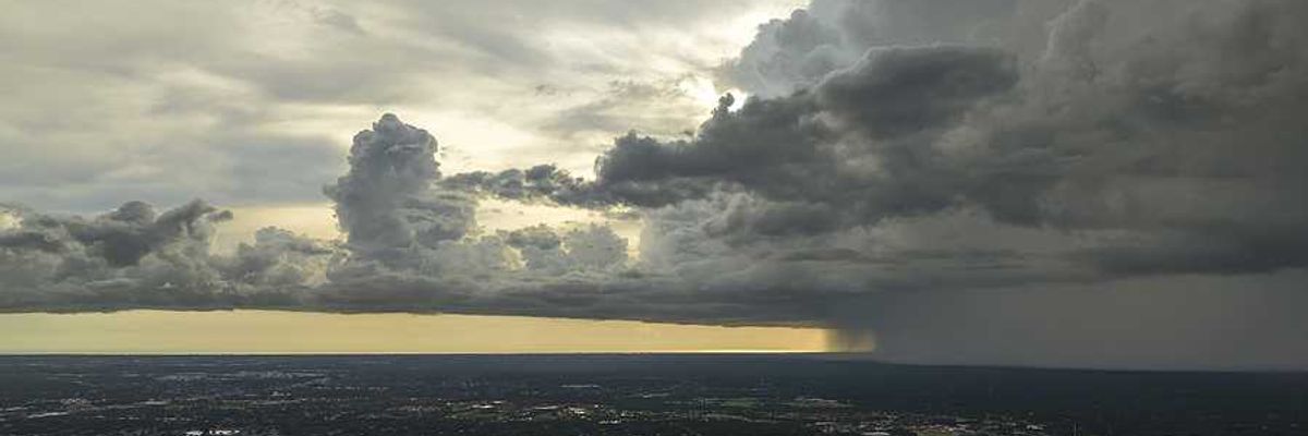 An aerial view of a city with a storm rapidly approaching