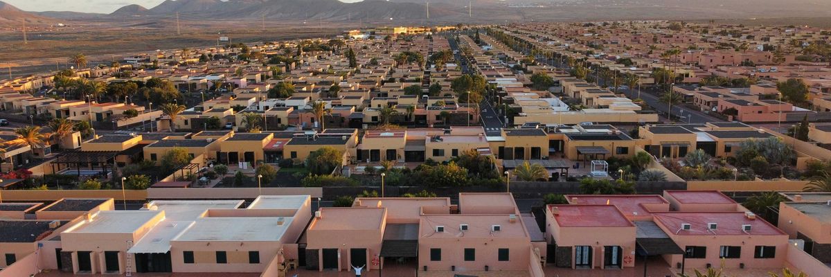 an aerial view of a city with mountains in the background