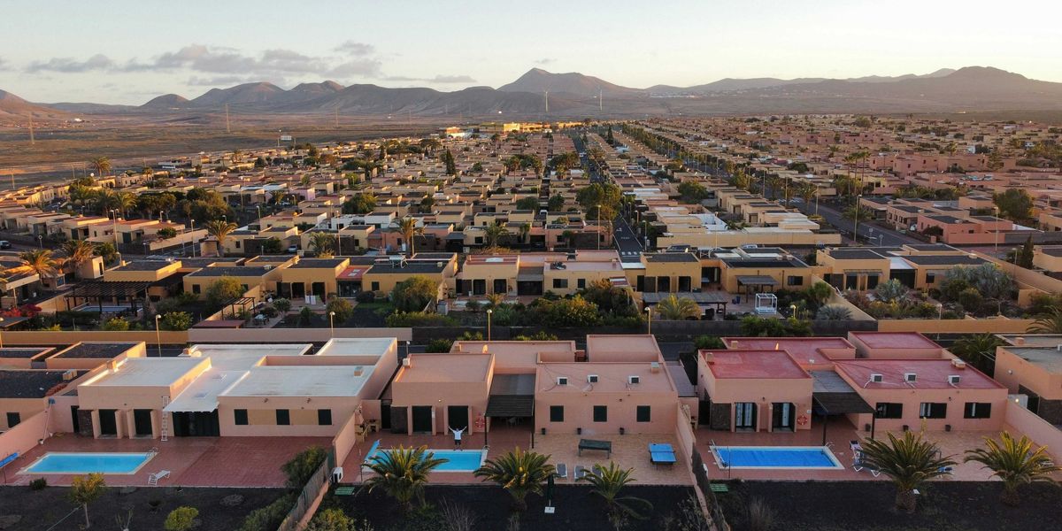 an aerial view of a city with mountains in the background