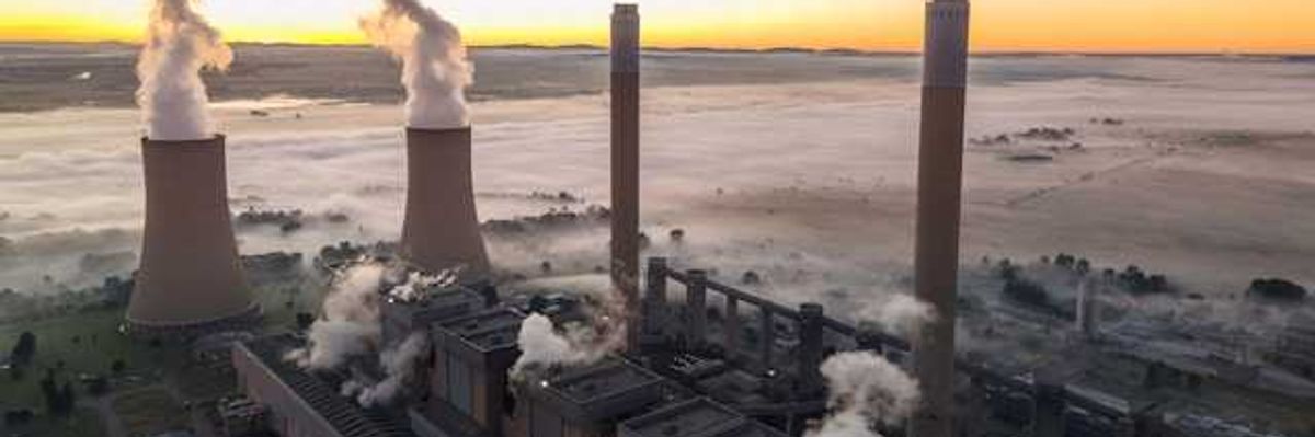 An aerial view of a coal plant surrounded by fog