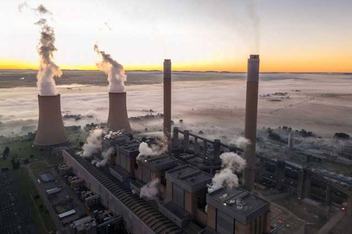 An aerial view of a coal plant surrounded by fog