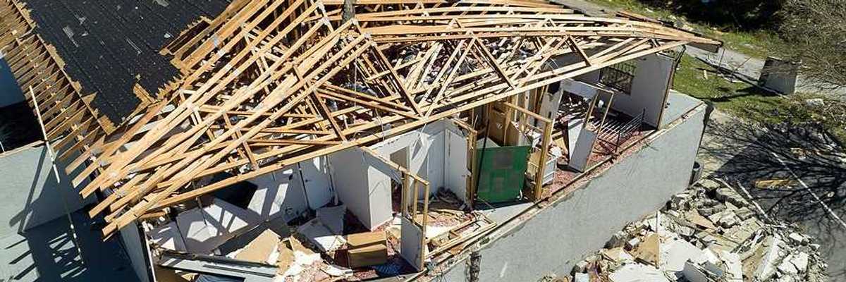 An aerial view of a home that has been damaged by a hurricane