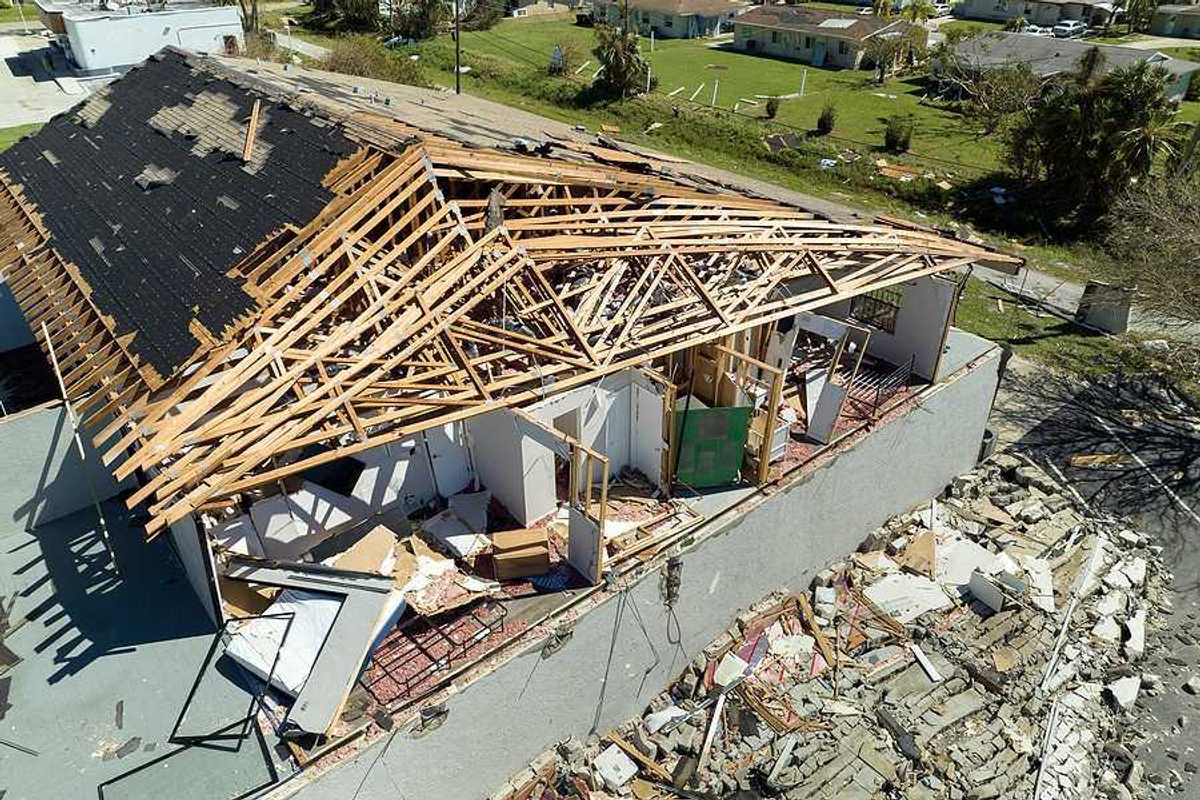 An aerial view of a home that has been damaged by a hurricane