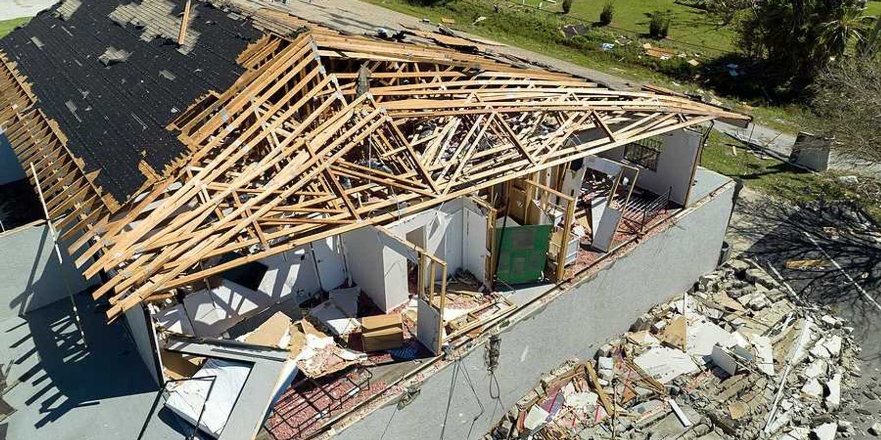 An aerial view of a home that has been damaged by a hurricane