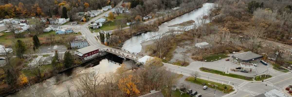 An aerial view of a new england town bisected by a river