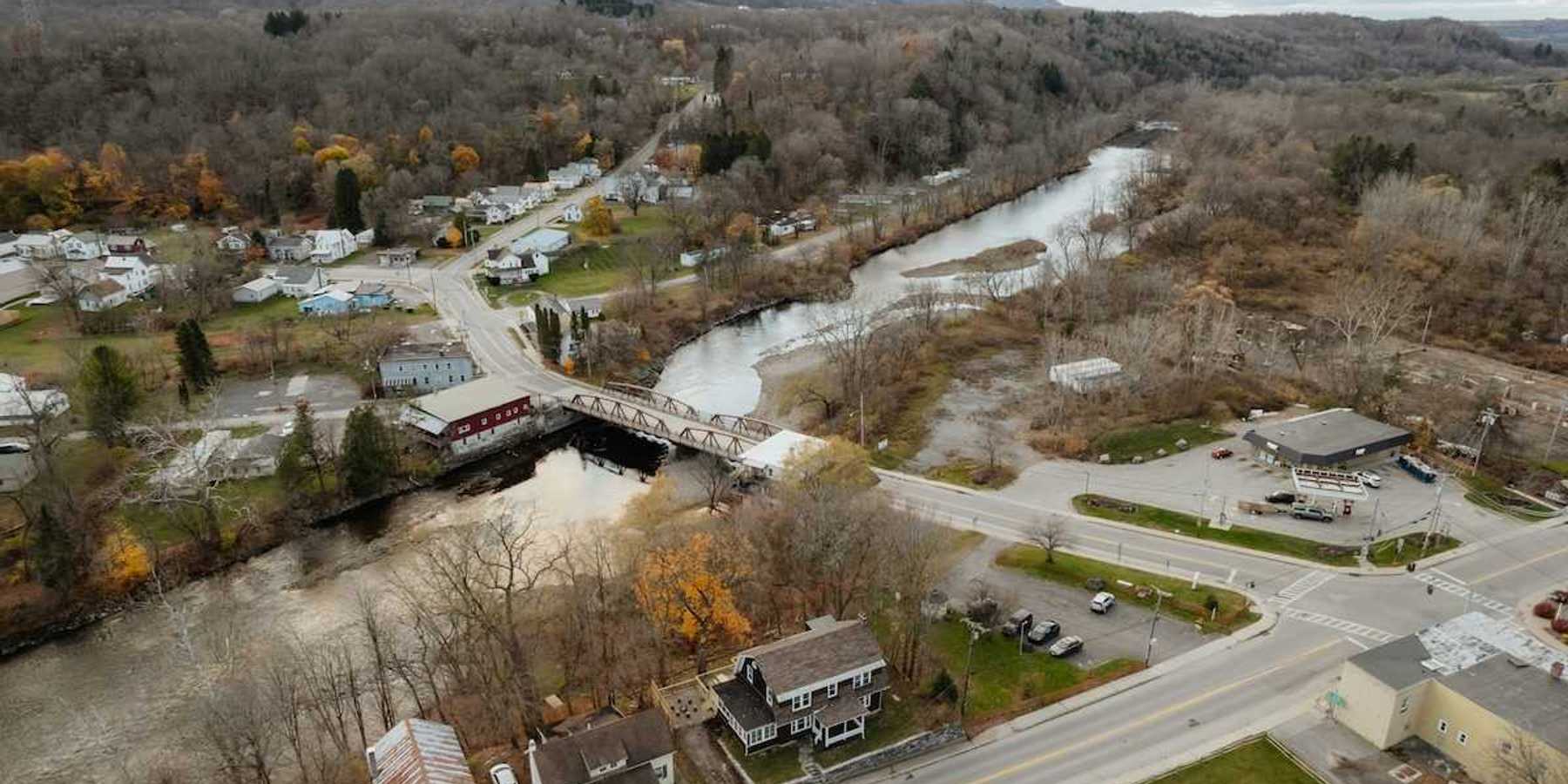 An aerial view of a new england town bisected by a river