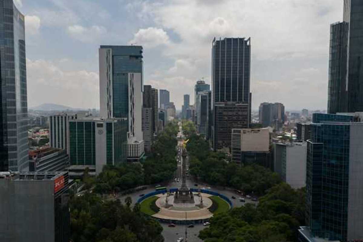 An aerial view of a roundabout with tall city buildings in the background