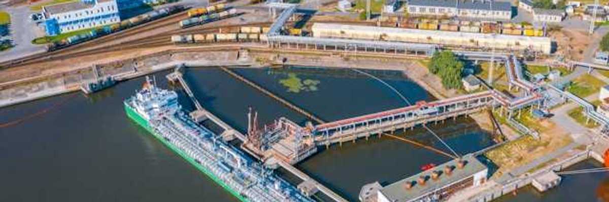An aerial view of a ship docked at an oil refinery