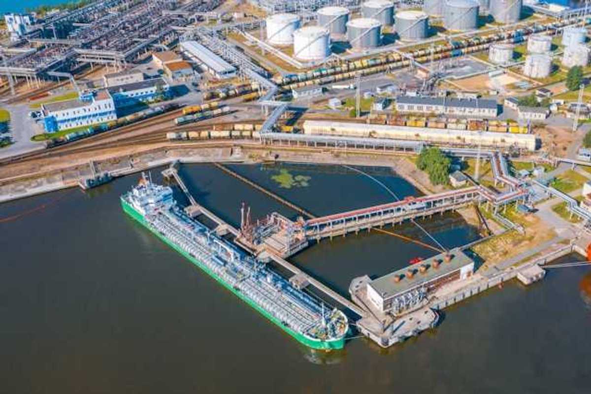 An aerial view of a ship docked at an oil refinery