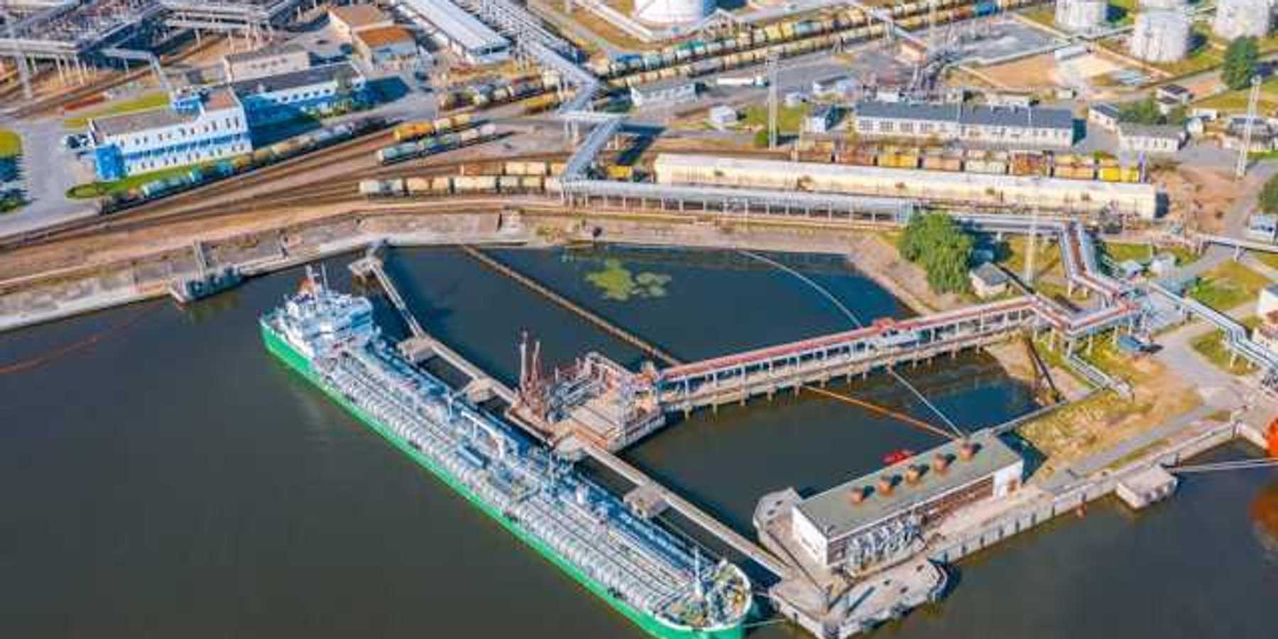 An aerial view of a ship docked at an oil refinery