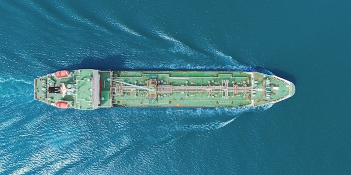 An aerial view of a tanker making its way across the ocean.