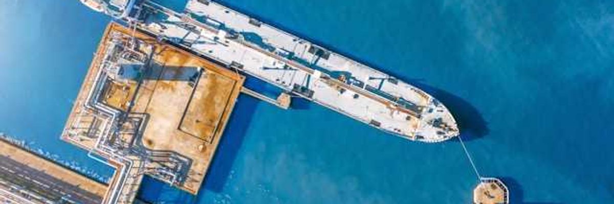 An aerial view of a tanker ship at a dock