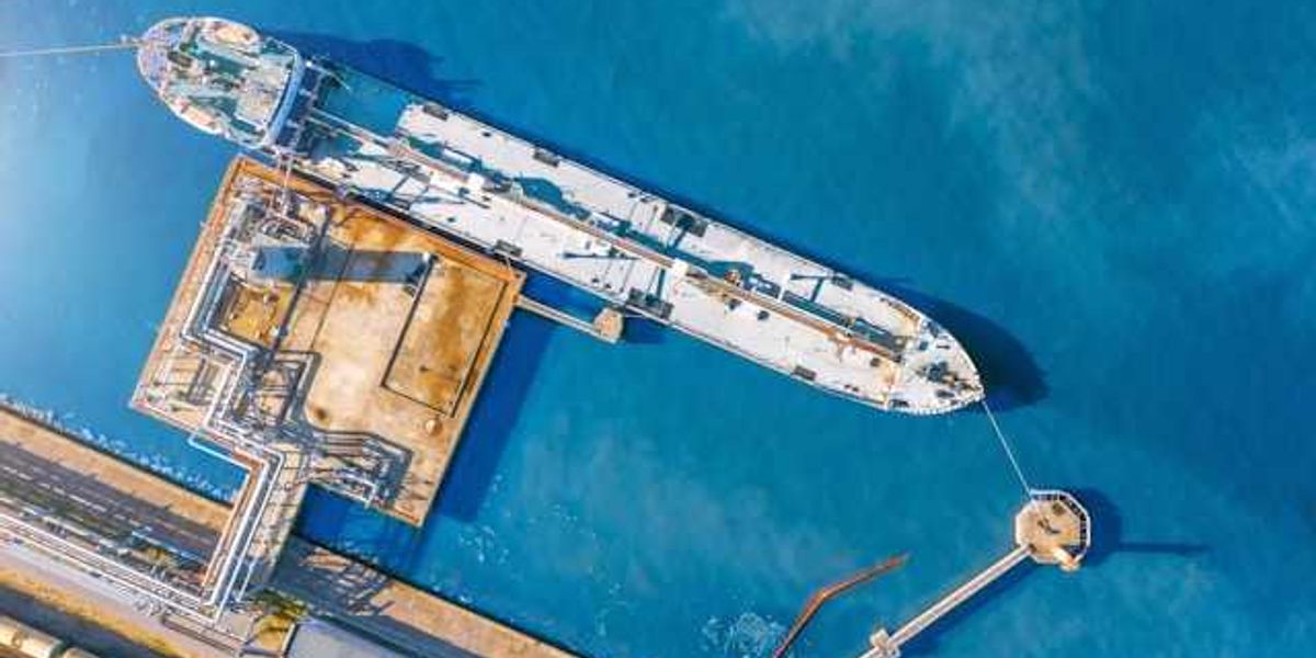 An aerial view of a tanker ship at a dock