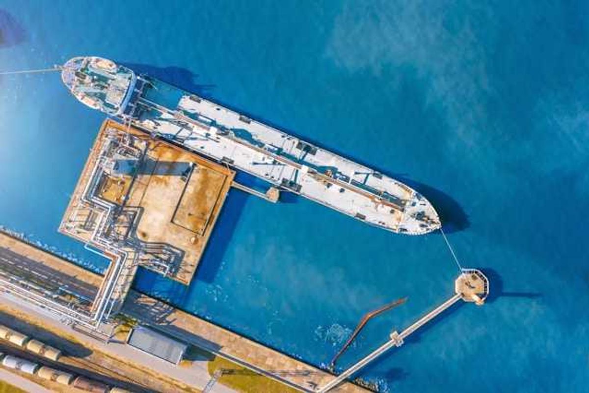 An aerial view of a tanker ship at a dock