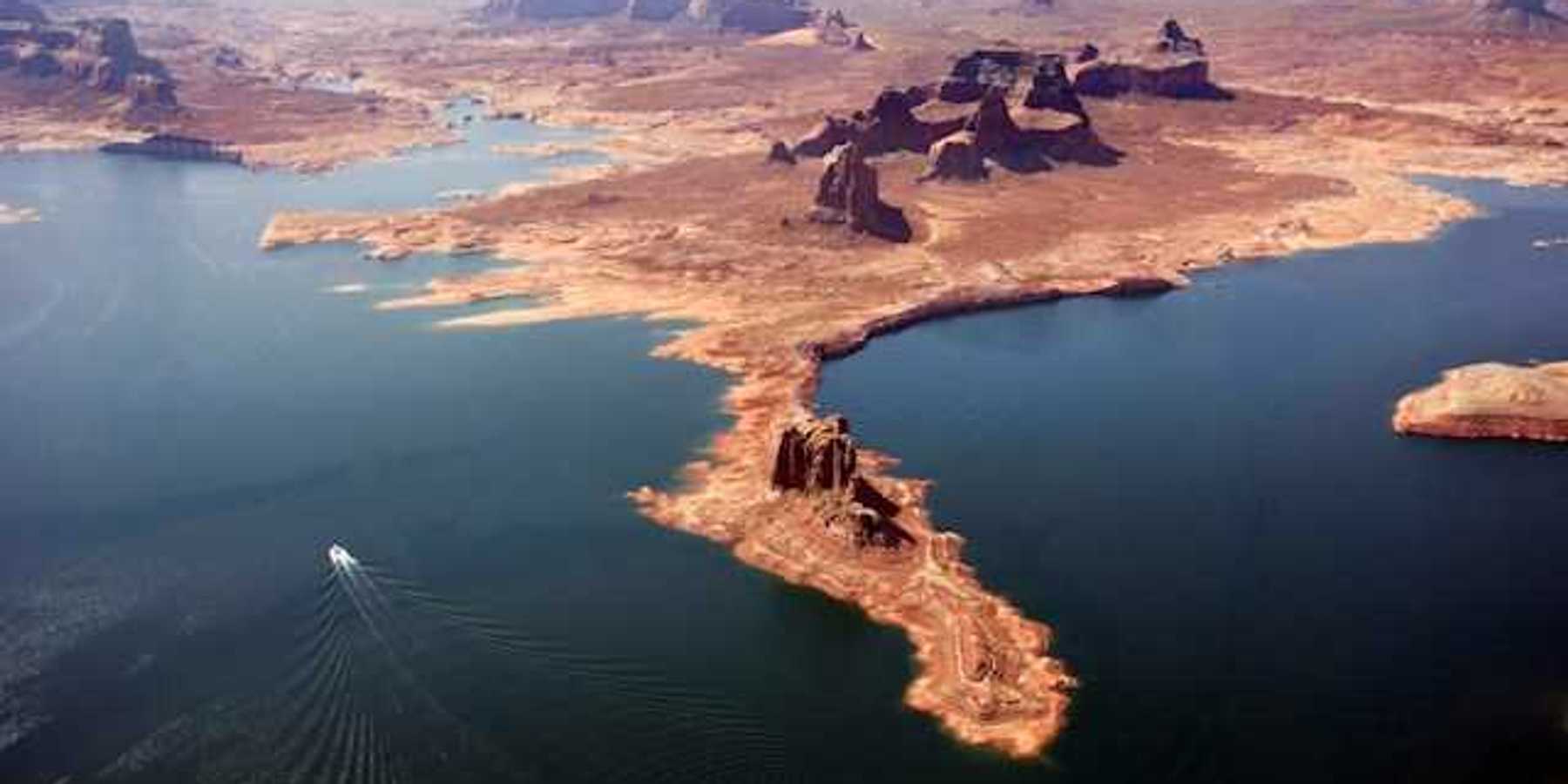 An aerial view of Lake Powell with boats navigating through the water