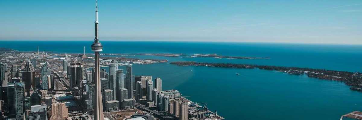 An aerial view of the city of Toronto with Lake Ontario in the background
