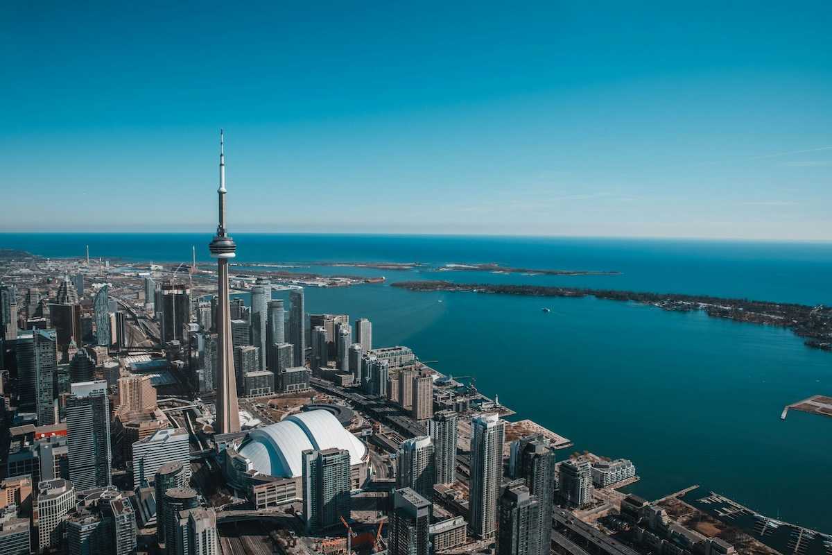 An aerial view of the city of Toronto with Lake Ontario in the background