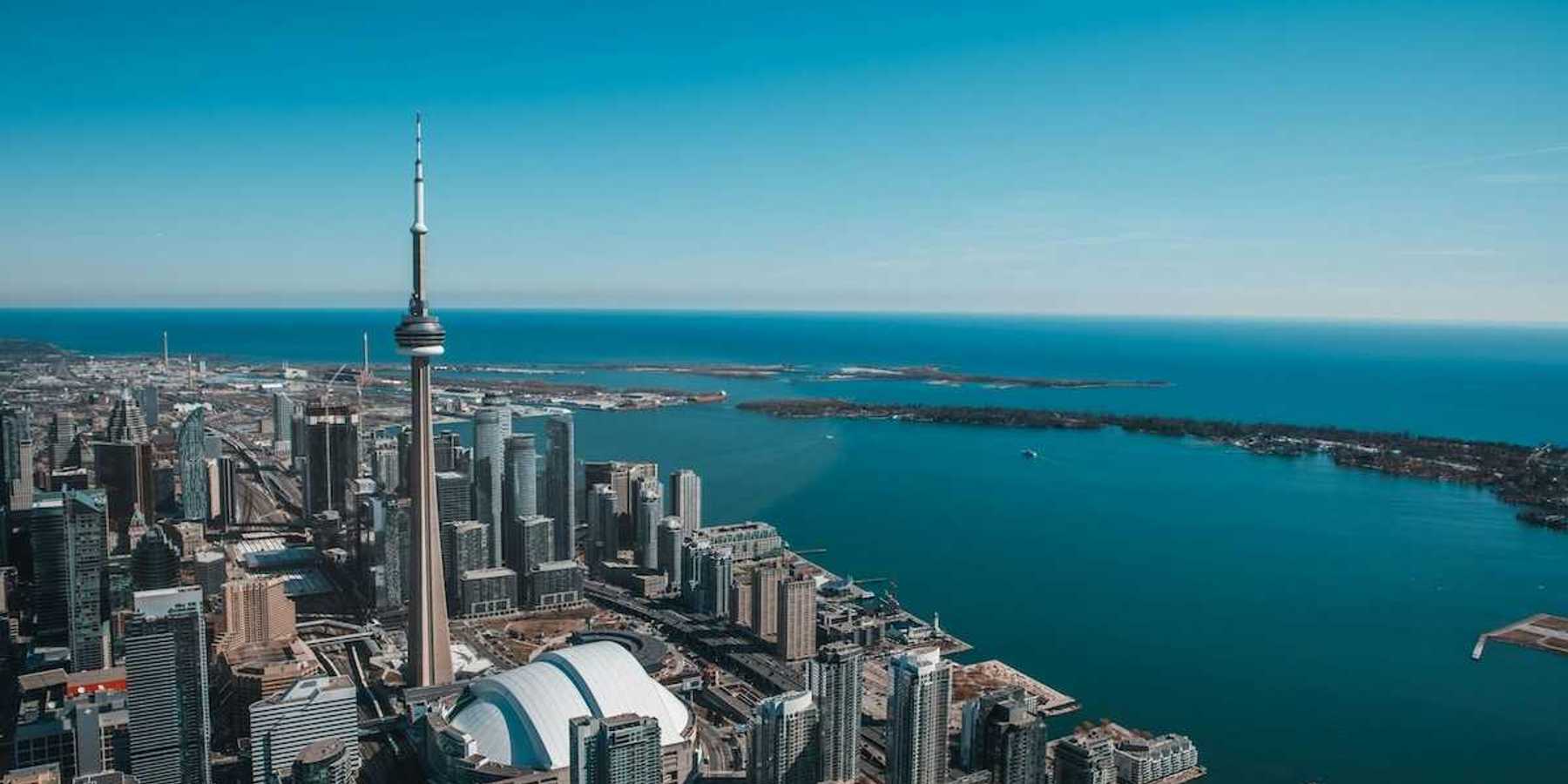 An aerial view of the city of Toronto with Lake Ontario in the background