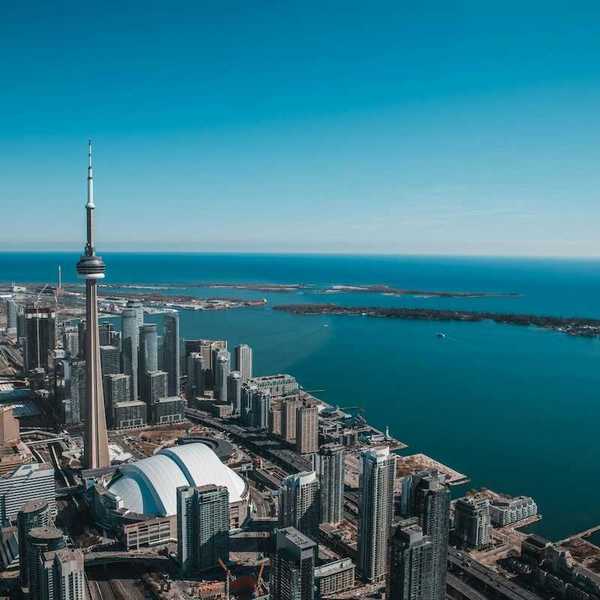 An aerial view of the city of Toronto with Lake Ontario in the background
