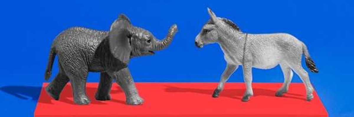An elephant and a donkey figurine on a red platform with a blue background