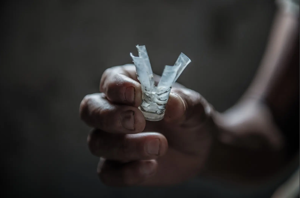 An environmental defender in Honduras holds a plastic shell shot at close range toward activists with the Civic Council of Popular and Indigenous Organizations as they protested the Agua Zarca Dam.