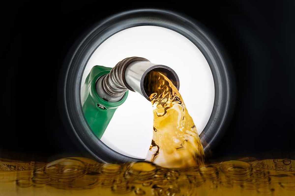 An illustration of a gas pump pouring gas into a gas tank