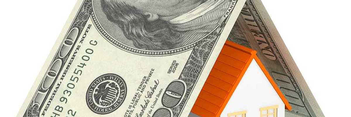 An illustration of a house covered in a folded $100 bill