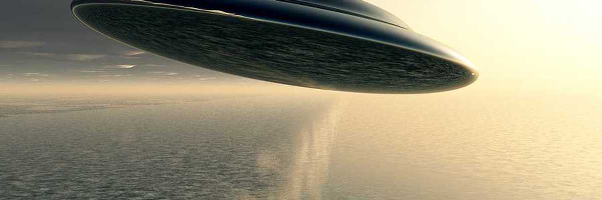 An illustration of a saucer-like space ship flying against a cloudy sky